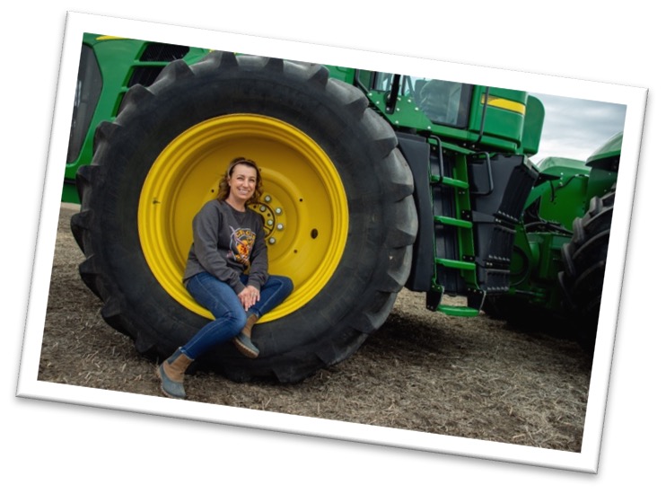 Jessica Canning sitting in tractor wheel well